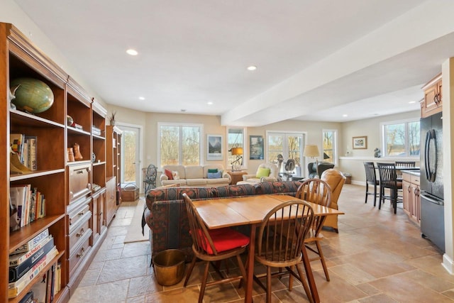 dining space with recessed lighting, french doors, baseboards, and stone tile floors