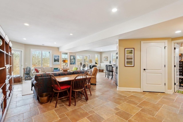 dining space with baseboards, stone tile flooring, and recessed lighting