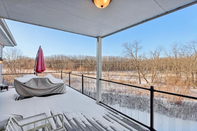 view of snow covered back of property