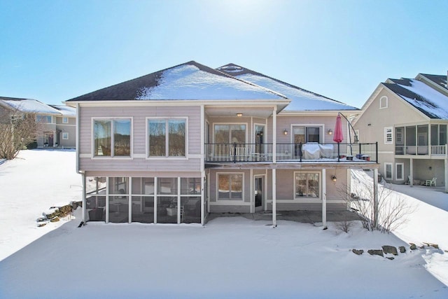 snow covered property featuring a balcony