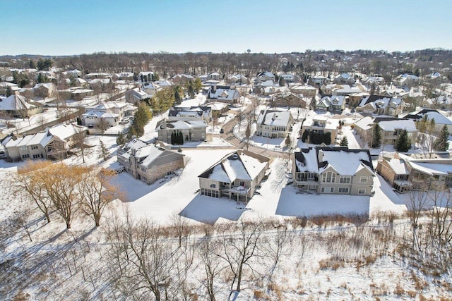 snowy aerial view with a residential view