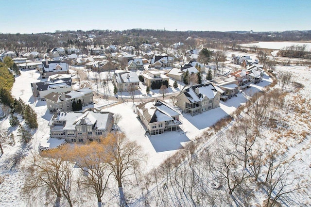 snowy aerial view with a residential view