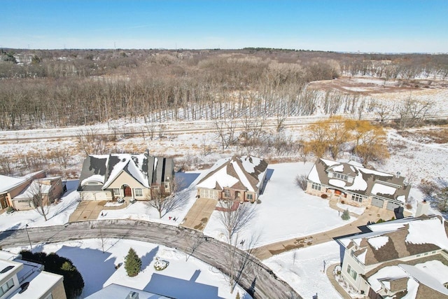 snowy aerial view with a residential view