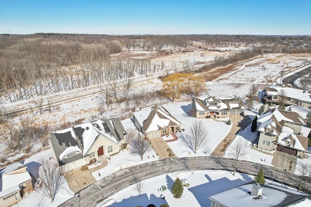 snowy aerial view with a residential view