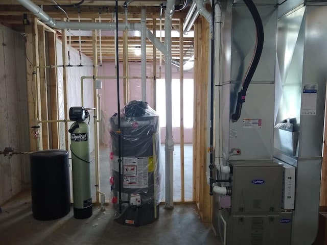 utility room featuring gas water heater and heating unit