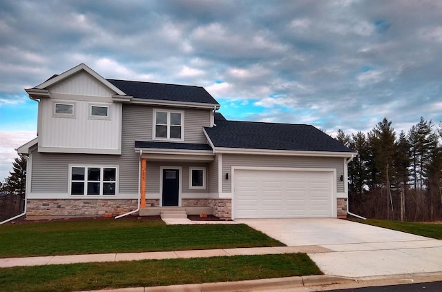 view of front of home with an attached garage, stone siding, concrete driveway, and a front yard