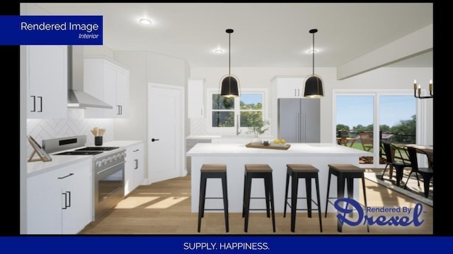 kitchen with a kitchen island, appliances with stainless steel finishes, light countertops, white cabinetry, and pendant lighting