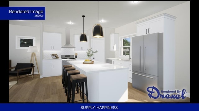 kitchen with wood finished floors, a kitchen island, white cabinets, light countertops, and wall chimney range hood