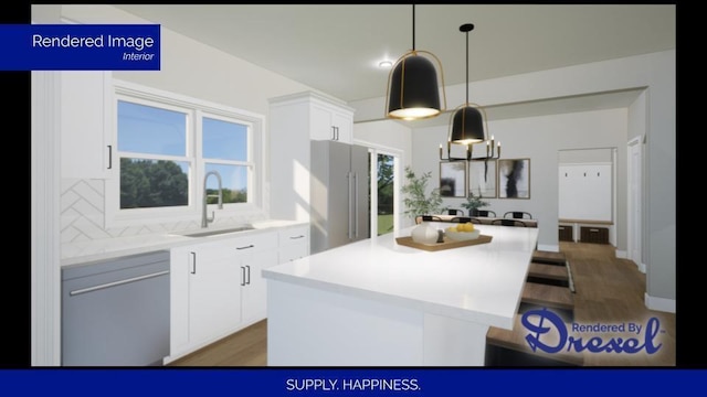 kitchen featuring a sink, white cabinetry, light countertops, appliances with stainless steel finishes, and a center island