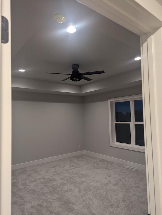 unfurnished room with baseboards, visible vents, and light colored carpet