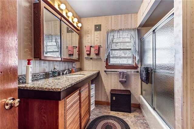 bathroom with vanity and combined bath / shower with glass door