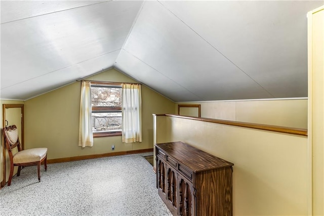 additional living space featuring lofted ceiling