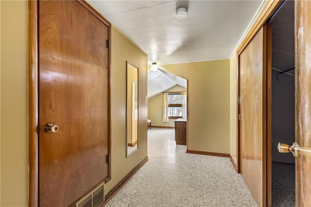 hallway featuring lofted ceiling