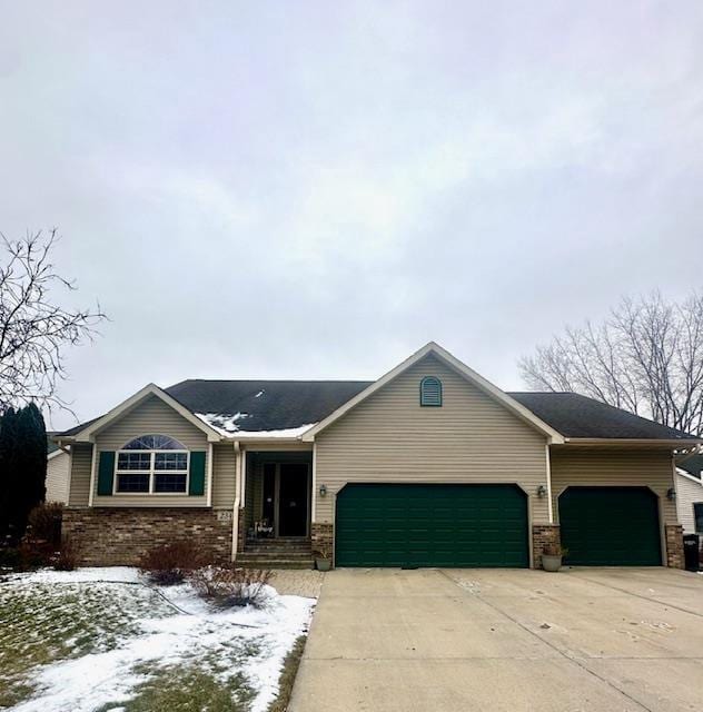 ranch-style house with a garage, brick siding, and driveway