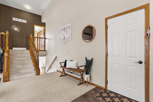 entryway featuring stairs, carpet flooring, baseboards, and visible vents