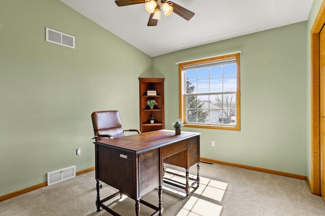 office space with visible vents, light carpet, and vaulted ceiling