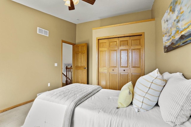 bedroom with visible vents, light carpet, a ceiling fan, a closet, and baseboards