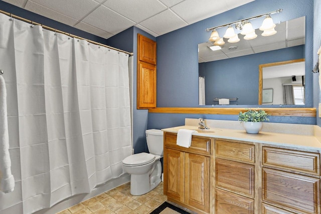 bathroom with vanity, a shower with shower curtain, toilet, and a paneled ceiling