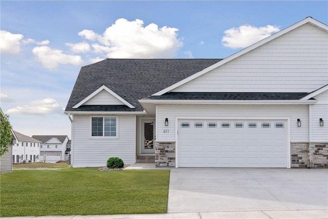 view of front of home featuring a garage and a front yard