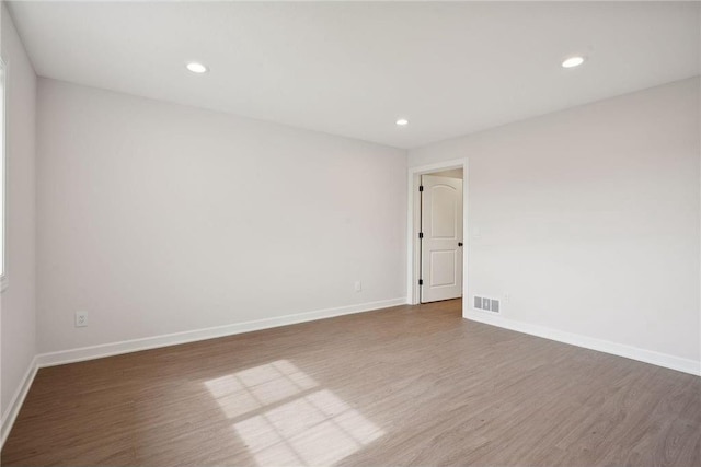 unfurnished room with hardwood / wood-style floors