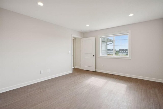 unfurnished room with dark hardwood / wood-style flooring