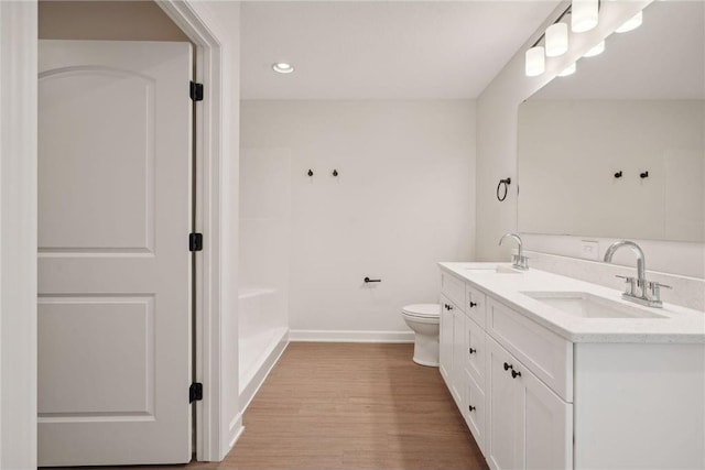 bathroom featuring hardwood / wood-style flooring, vanity, and toilet