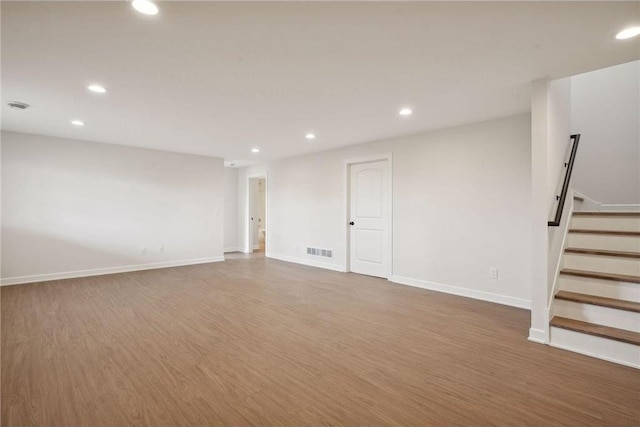 basement with hardwood / wood-style flooring