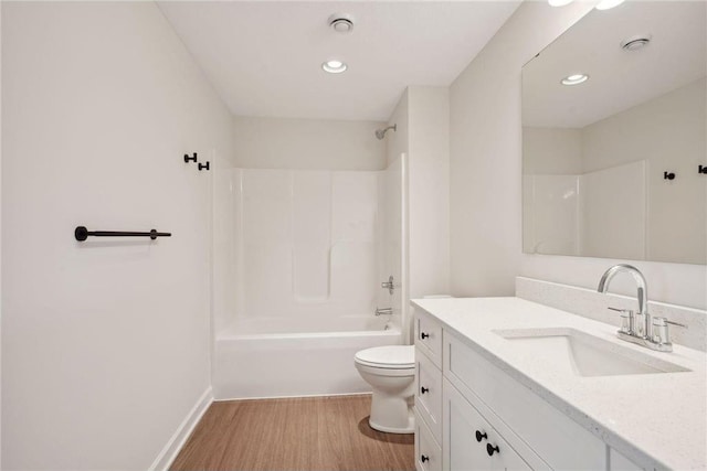 full bathroom with hardwood / wood-style flooring, shower / washtub combination, toilet, and vanity