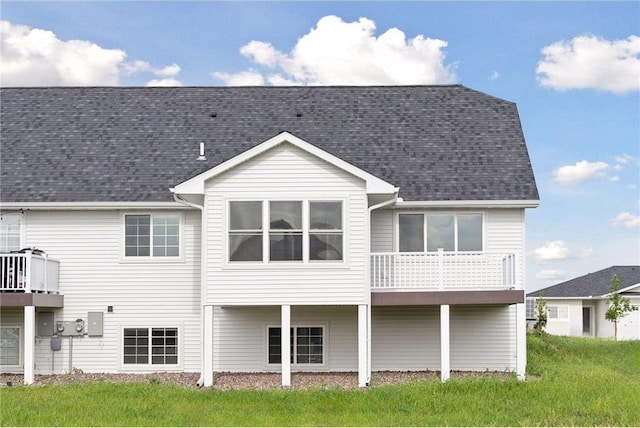 rear view of property featuring a yard