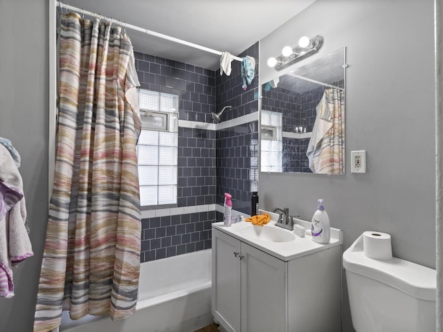 full bathroom featuring vanity, shower / bathtub combination with curtain, and toilet