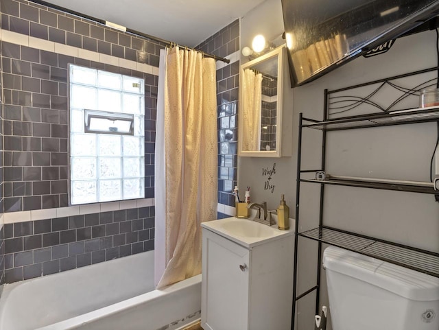 full bathroom featuring a healthy amount of sunlight, shower / bathtub combination with curtain, vanity, and toilet