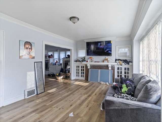 living room featuring wood-type flooring and crown molding