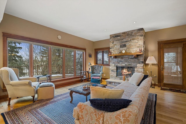 living room featuring a fireplace and light wood-type flooring