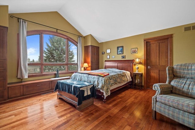 bedroom featuring vaulted ceiling and light hardwood / wood-style floors