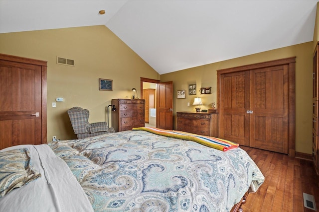 bedroom with vaulted ceiling and hardwood / wood-style floors