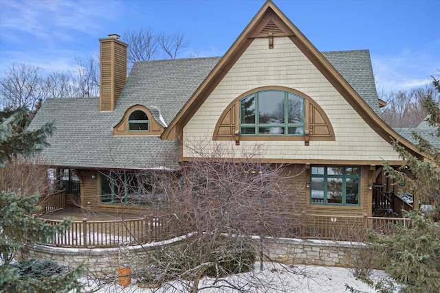 view of snow covered rear of property