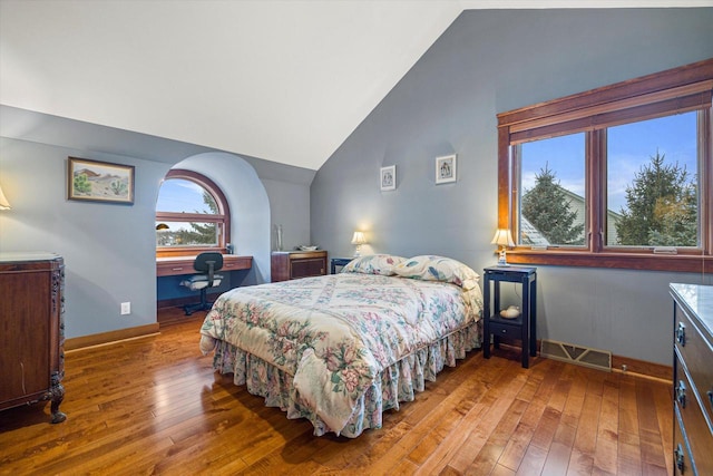 bedroom featuring hardwood / wood-style floors and vaulted ceiling