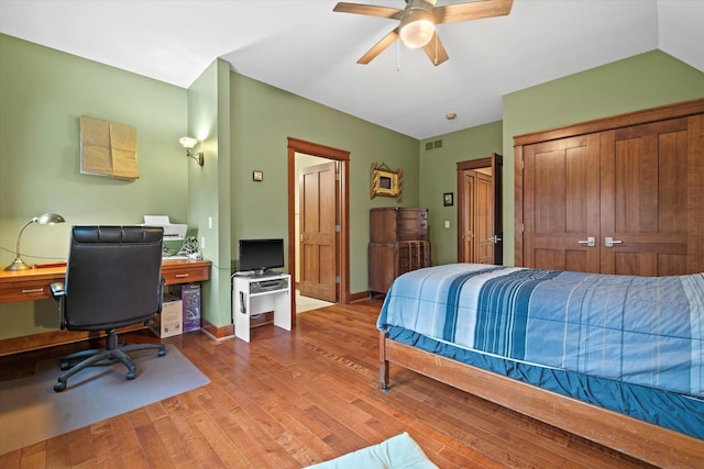 bedroom featuring hardwood / wood-style flooring, ceiling fan, and a closet