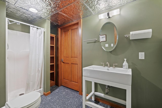 bathroom featuring toilet and a shower with shower curtain