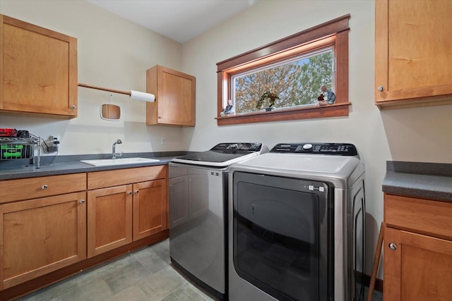 laundry area with cabinets, sink, and washing machine and dryer