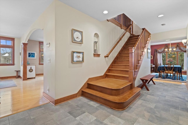 stairs with an inviting chandelier