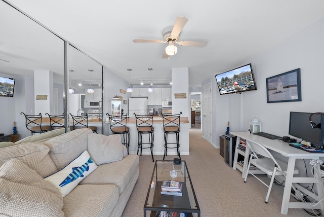 carpeted living room featuring ceiling fan