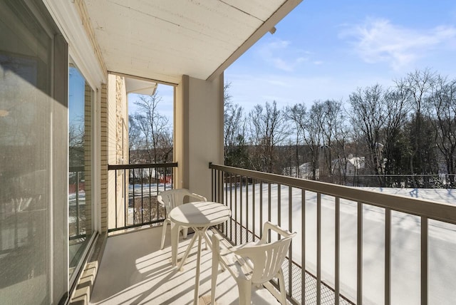 view of snow covered back of property