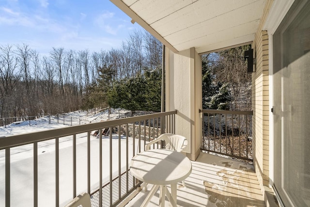 view of snow covered back of property