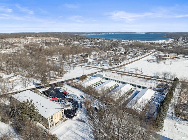 snowy aerial view featuring a water view