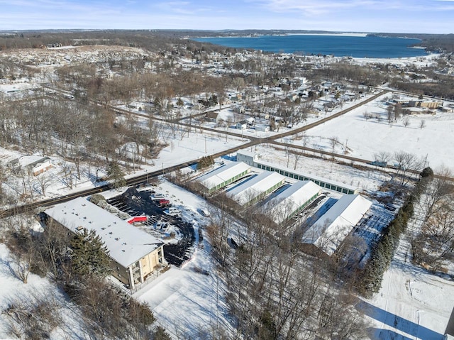 snowy aerial view featuring a water view