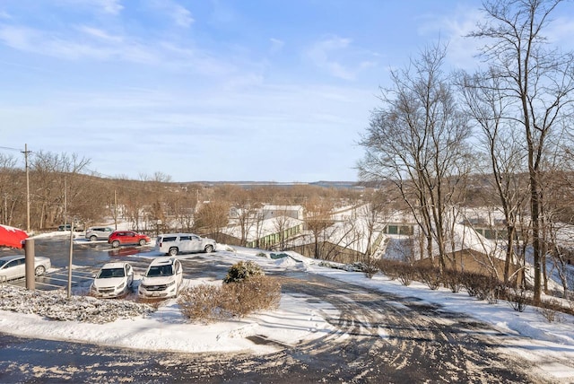 view of snow covered parking area