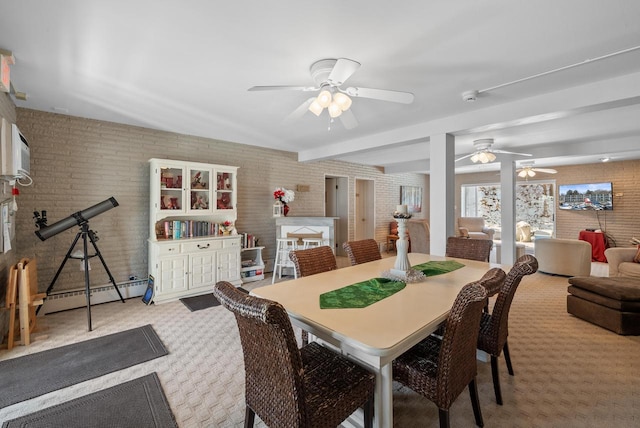 dining room with beamed ceiling, ceiling fan, brick wall, carpet, and a baseboard heating unit