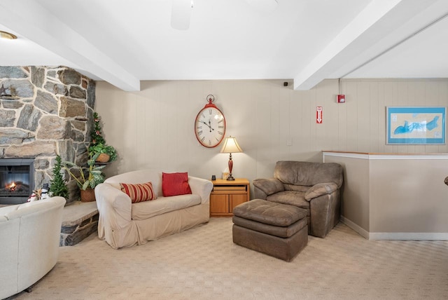 interior space with light carpet, a fireplace, wooden walls, and beamed ceiling