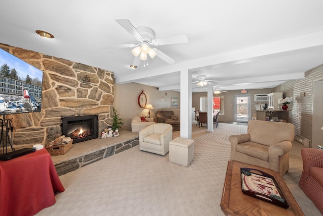 living room with ceiling fan, a baseboard heating unit, carpet floors, a fireplace, and beamed ceiling